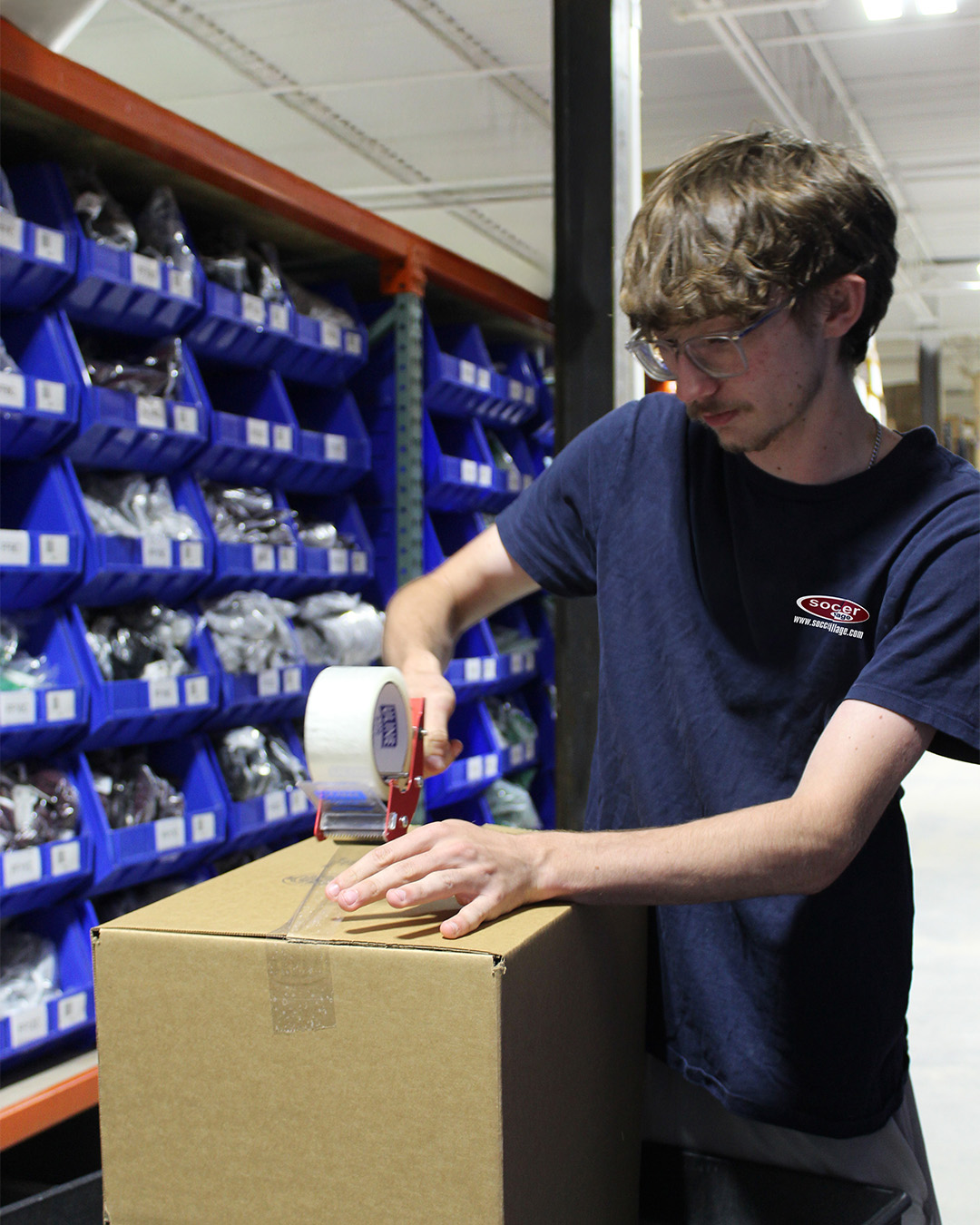 Team processing is hands on with uniforms, customization, and warehouse work!